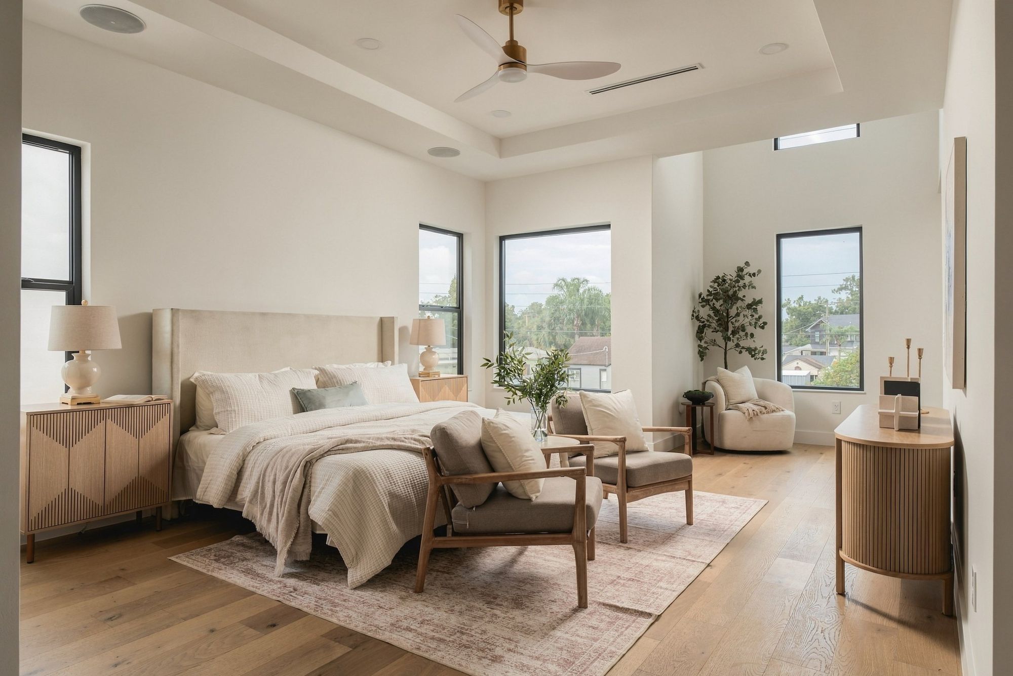 Bright primary bedroom with a seating area