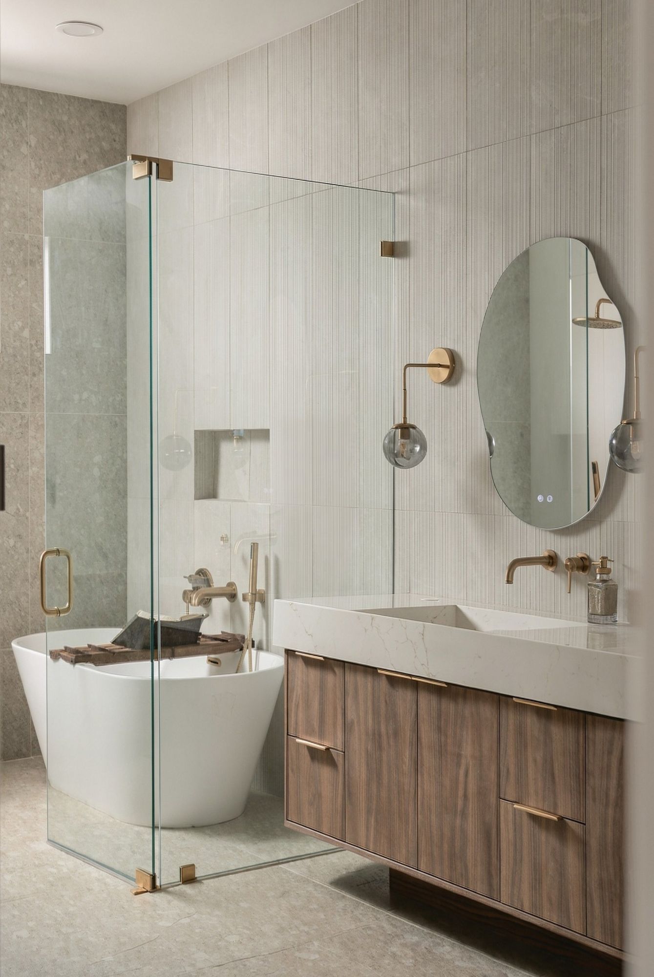 Spa-style bath with a freestanding tub and glass shower
