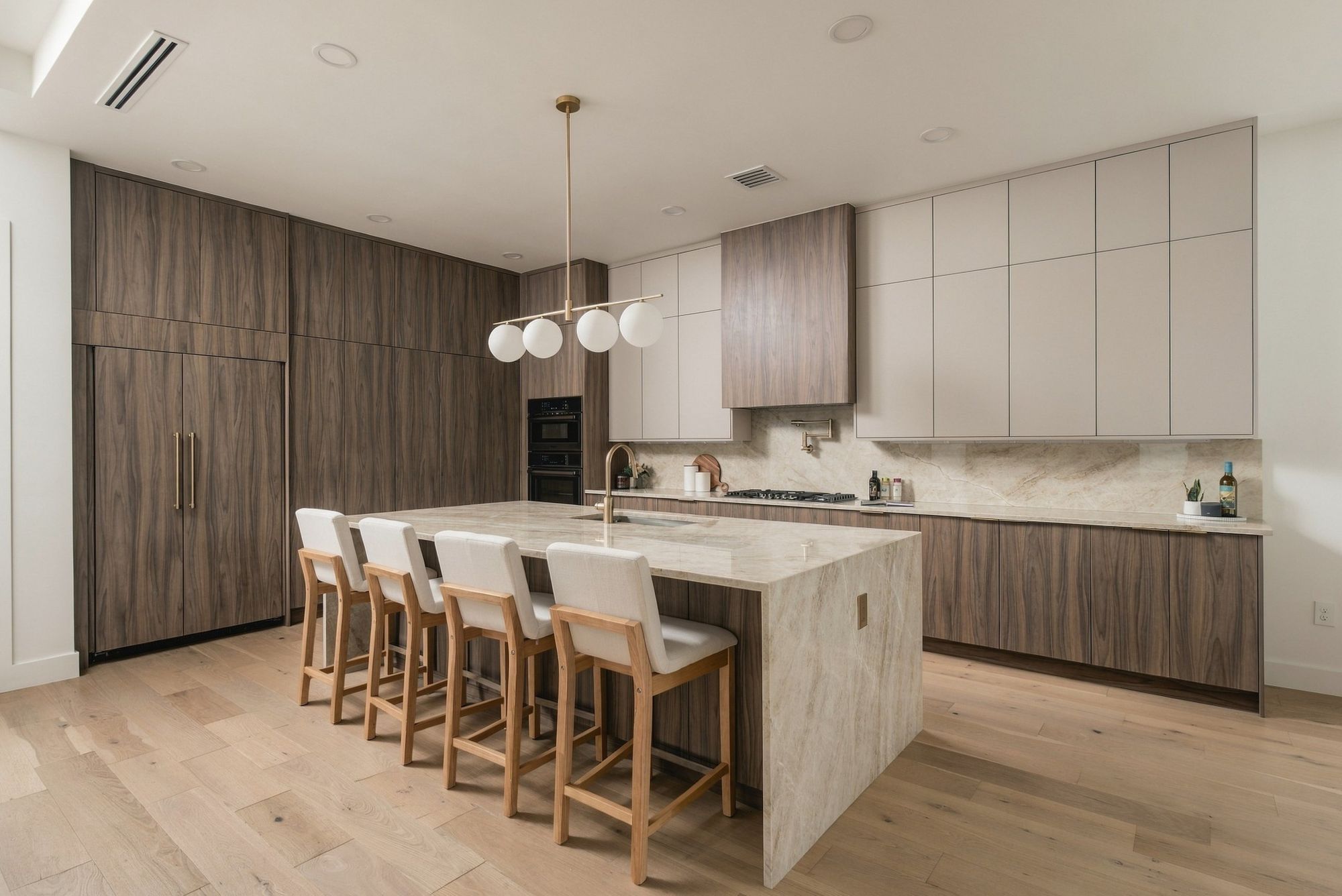Modern kitchen with a waterfall stone island and walnut cabinetry